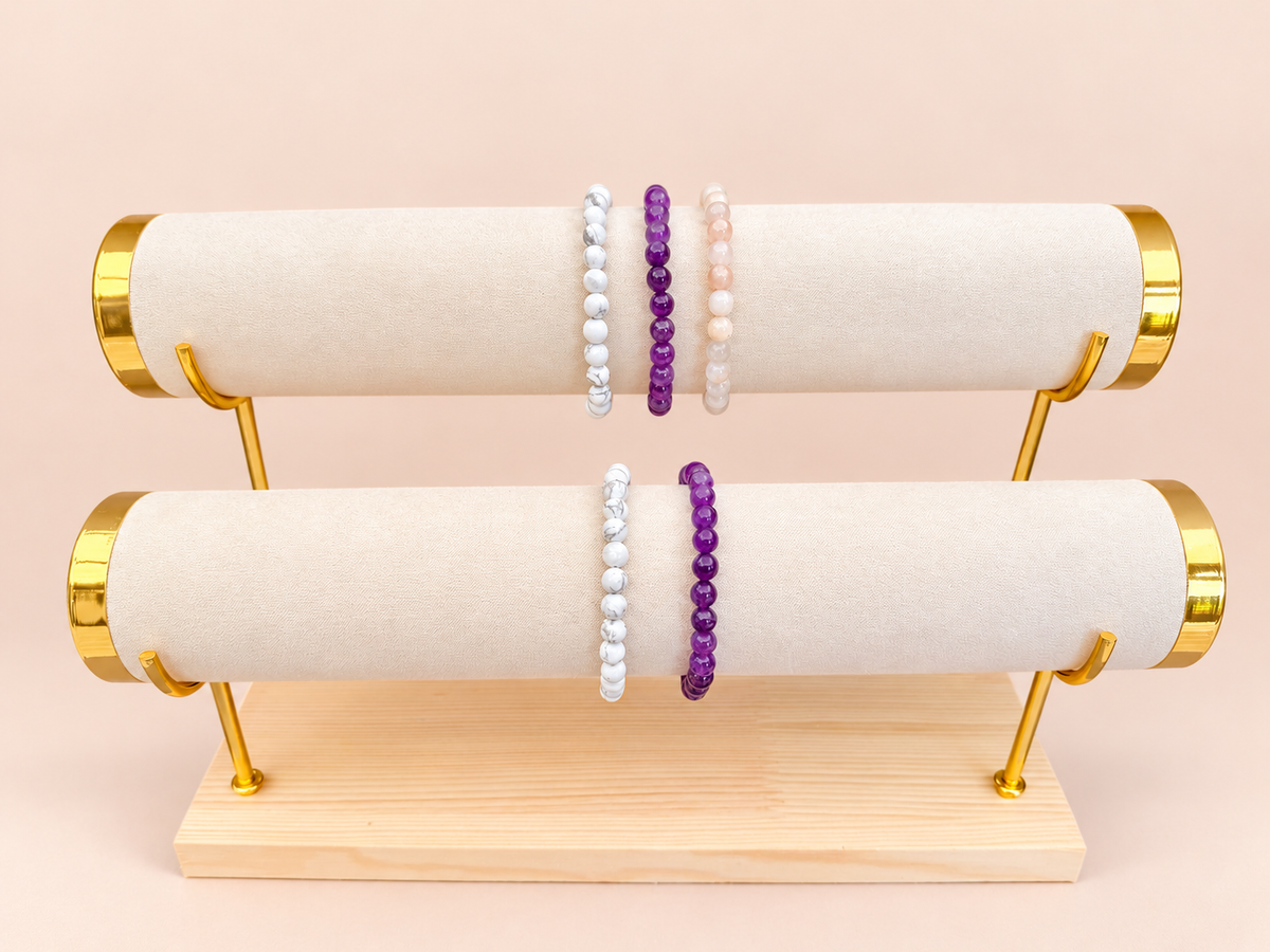 A Little More Peace bracelet trio on top and pairing below on blush background