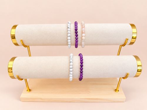 A Little More Peace bracelet trio on top and pairing below on blush background