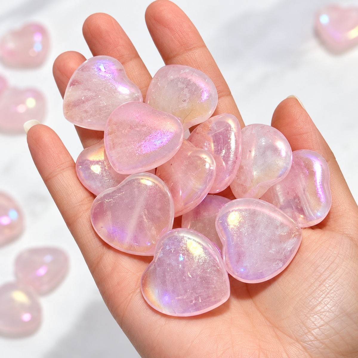 Aura Rose Quartz hearts shown in hand for scale
