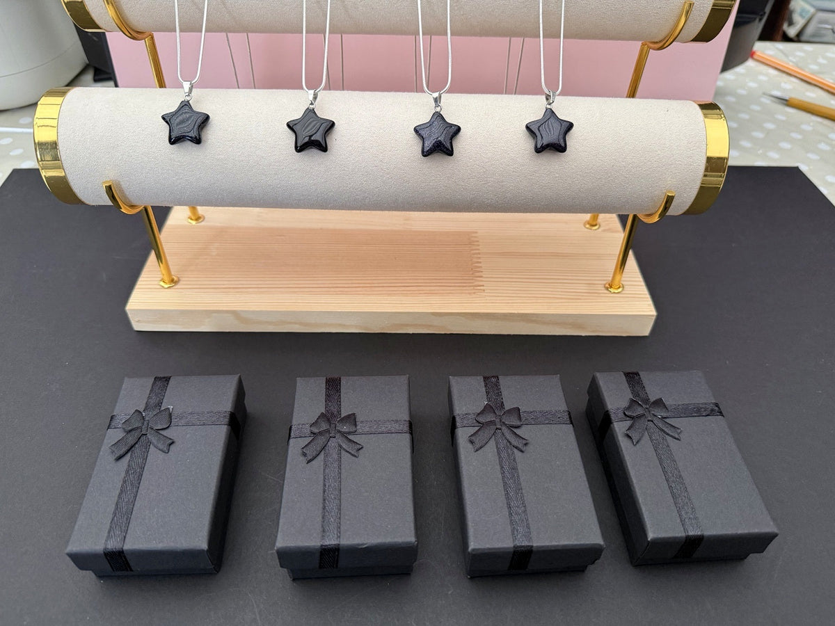 Four blue goldstone star necklaces with black gift boxes