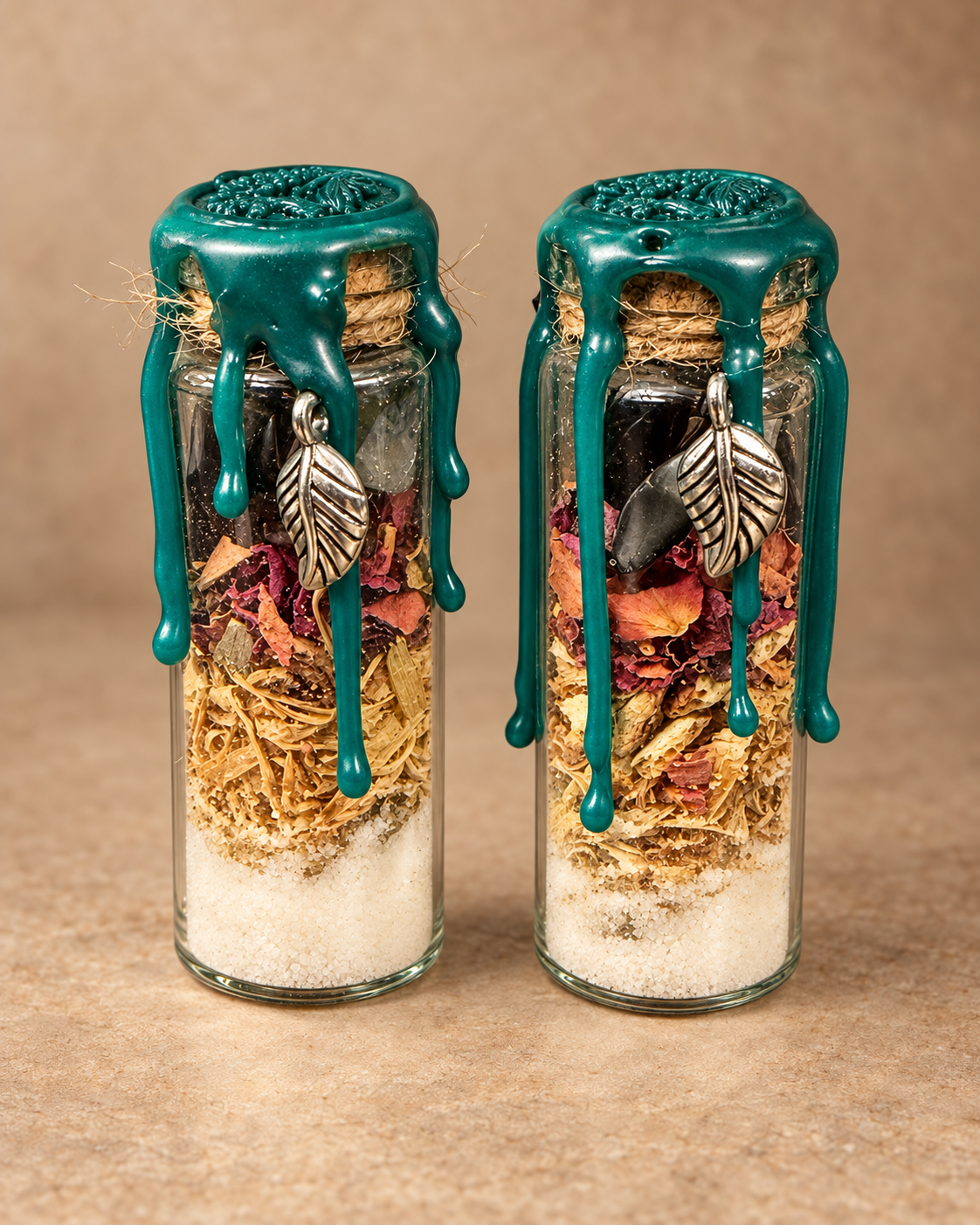 Two handmade Hedge Witch spell jars with leaf charms